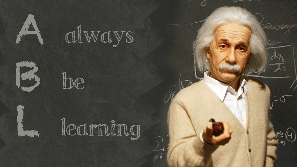 Einstein in front of a chalkboard that reads Always Be Learning.