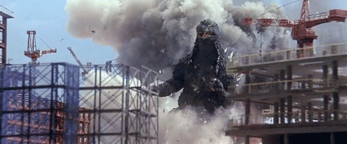 Godzilla busting through buildings and destroying them on a whim.